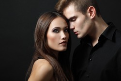Sexy passion couple, beautiful young man and woman closeup, studio shot over black