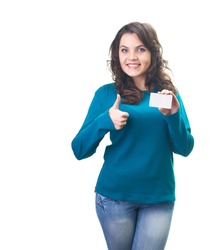 Attractive smiling young woman in a blue shirt holding a poster in her left hand and her right hand showing thumbs up. Isolated on white background