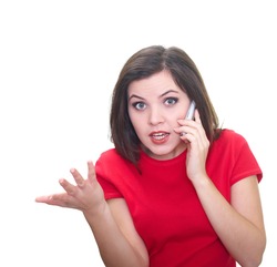 Attractive young woman in a red shirt talking on a mobile phone and explaining something. Isolated on white background