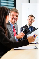 Business - businesspeople have a meeting with presentation in office, they negotiate a contract