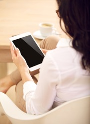 Corporate assitant checking information about business marketing through her digital tablet