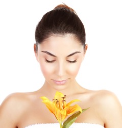 Photo of pretty woman enjoying dayspa, closeup portrait of attractive female with closed eyes holding yellow lily flower isolated on white background, luxury spa salon, beauty treatment concept