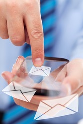 Businessman hands with futuristic transparent smartphone sending mail messages