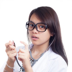 Portrait of a smiling female doctor with confident pose isolated on white background, model is a asian woman