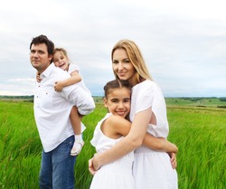 Happy young family with two children outdoors