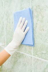 Female household, tile cleaning with rag and gloves