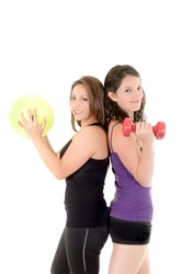 Two women doing exercises with barbell and ball isolated on white background