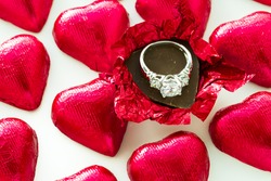 Heart shape chocolate candies wrapped in red foil for Valentine's Day.