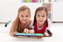 Little girls using tablet computer as art board - painting together