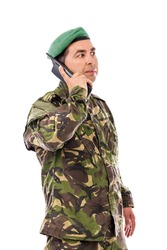 Young army soldier with beret speaking on phone isolated on white background