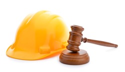 Labor law concept, wooden judge gavel and yellow helmet isolated on white background