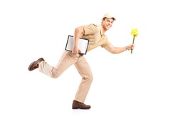 Full length portrait of a mailman delivering flowers, isolated on white background