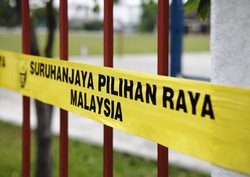 SUBANG JAYA, MALAYSIA - MAY 5: Yellow barrier tape of the Malaysian election commission at a polling station for the Malaysian 13th general election on May 5, 2013 in Subang Jaya, Malaysia.