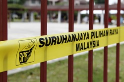 SUBANG JAYA, MALAYSIA - MAY 5: Yellow barrier tape of the Malaysian election commission at a polling station for the Malaysian 13th general election on May 5, 2013 in Subang Jaya, Malaysia.