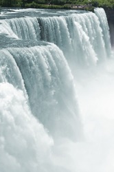 Vertical wide angle shot of the American side of Niagara falls from the Prospect Point , fast shutter speed to freeze the motion.