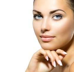 Beauty Portrait. Beautiful Spa Woman Touching her Face. Perfect Fresh Skin closeup. Isolated on White Background. Pure Beauty Model. Youth and Skin Care Concept