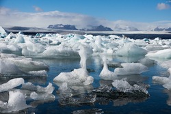 Sunny day at beautiful Glacier Lagoon full with big floating icebergs, Iceland