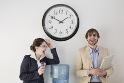 Business colleagues conversing at water cooler