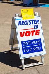Sign reading Last Day Register to Vote trying to get voters to signup for political voting registration.