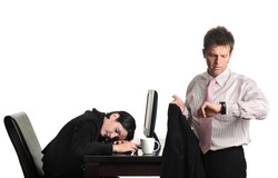 Job done. Conceptual image about the overtime work. The businessman looks at his watch while the businesswoman already sleeps on the desk.