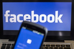 CHIANG MAI, THAILAND - OCTOBER 21, 2014: Facebook application sign in page on smartphone and facebook logo on background. Facebook is largest and most popular social networking site in the world.
