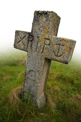 Gravestone with the initials RIP carved into it. Ancient gravesite in South Uist, Scotland.