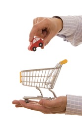 Shopping concept - Man putting a car on a trolley shopping