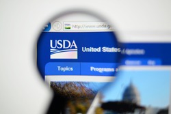 LISBON, PORTUGAL - December 9, 2014: Photo of the United States Department of Agriculture (USDA) homepage on a monitor screen through a magnifying glass.