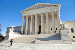 WASHINGTON, DC - DECEMBER 26: Tourists take photos of the Supreme Court Building in Washington, DC on December 26, 2014.