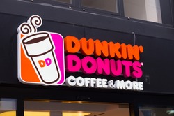 ESSEN, GERMANY - SEPTEMBER 14, 2014: Dunkin' donuts sign. Since its founding, the company has grown to become one of the largest coffee and baked goods chains in the world, with 11,000 restaurants.