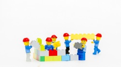 Orvieto, Italy - January 16th 2015: team of workman Lego mini figure build a wall. Lego is a popular line of construction toys manufactured by the Lego Group