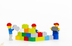 Orvieto, Italy - January 16th 2015: team of workman Lego mini figure build a wall. Lego is a popular line of construction toys manufactured by the Lego Group