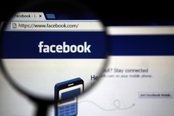 BANGKOK-JANUARY 17 2015: Magnifying Facebook.com Home Page. Facebook is an online social networking service headquartered in Menlo Park, California.