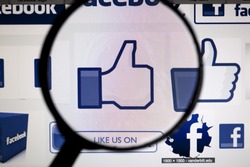 BANGKOK, FEBRUARY 13, 2015: Facebook's Likes being magnified. Facebook is an online social networking service headquartered in Menlo Park, California.