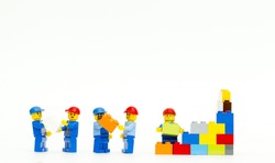 Orvieto, Italy - March 8th 2015: group of workman Lego mini figure build a wall. Lego is a popular line of construction toys manufactured by the Lego Group