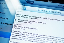 PARIS, FRANCE - SEPTEMBER 18, 2014: Terms and Conditions for iPhone, iPad, iPod and other iOS Apple device as seen on Retina iPad Air display with update bar during iOS 8 update. Tilt-shift lens used