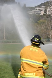 LAGUNA BEACH, CA - FEB 19: Firefighter recruit sprays water during fire fighting drills at the local Fire Department training area on February 19, 2009 in Laguna Beach, California.