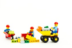 Orvieto, Italy - May 18th 2015: team of workman Lego mini figure build a wall. Lego is a popular line of construction toys manufactured by the Lego Group