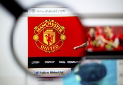 LISBON, PORTUGAL - June 6, 2015: Photo of: www.manutd.com, Manchester United homepage on a monitor screen through a magnifying glass.