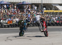 Lvov, Ukraine - June 7, 2015: Unknown stunt bikers entertain the audience before the start of the championship of drifting near Arena - Lvov stadium in Lvov, Ukraine.