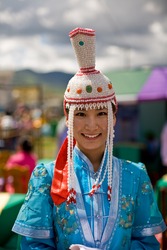 ULAN BATOR, MONGOLIA - JULY 11: Mongolian Woman wears a traditional ethnic dress during the Nadaam National Games. July 11, 2008 Ulan Bator, Mongolia