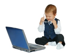 Baby businessman does not like what he sees on the computer or is tired after a long day at work