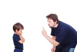 A father is threatening his little boy with a finger