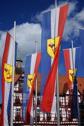 BAD URACH, GERMANY - CIRCA AUGUST 2015 Houses and flags on the Marktplatz square