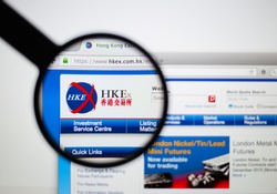 LISBON - JANUARY 7, 2016: Photo of Hong Kong Stock Exchange homepage on a monitor screen through a magnifying glass.