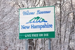 NASHUA, NH FEBRUARY 5: New Hampshire welcome sign and trees are covered with fresh fallen snow on February 5, 2016 in Nashua, NH. A Donald Trump campaign event was canceled due to the snow storm.