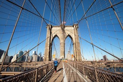 NEW YORK CITY - JANUARY 3: An unidentified woman jogs on the pedestrian walkway of the Brooklyn Bridge from Manhattan to Brooklyn on January 3, 2016 in New York City.