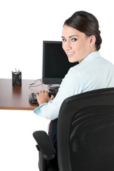 Young, beautiful businesswoman typing on computer keyboard at work, happy and smiling, isolated on white background