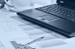 Workplace of the businessman. Laptop in an environment of financial calculations