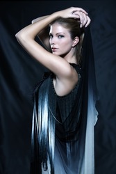 fashion pictures of a beautiful woman wearing silk fringe black and white dress chinese style doing martial arts posture